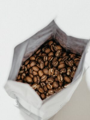 brown coffee beans inside white sack